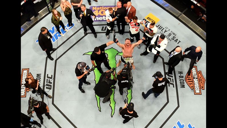 Michael Bisping celebrates after his knockout win over Luke Rockhold earned him the UFC middleweight championship on Saturday, June 4.