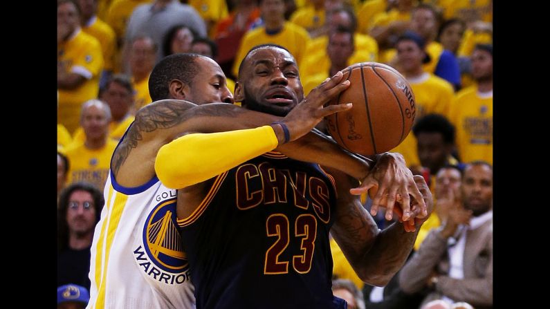 Cleveland's LeBron James is corralled by Golden State's Andre Iguodala during Game 2 of the NBA Finals on Sunday, June 7.