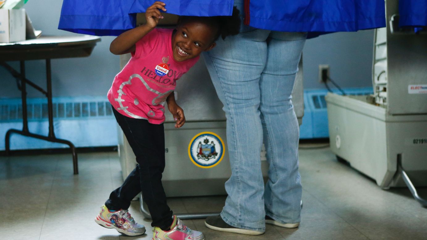 A girl looks out of a voting booth in Philadelphia on Tuesday, April 26.