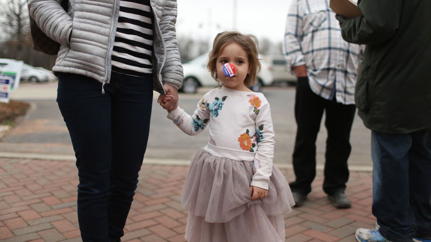 Shuli Horowitz, 4, holds her mother's hand as they leave a polling place in Highland Park, Illinois, on Tuesday, March 15.