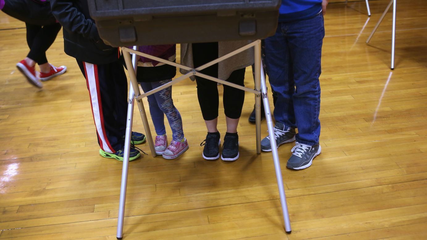 Children accompany their mother as she casts a vote in Stamford, Connecticut, on Tuesday, April 26.