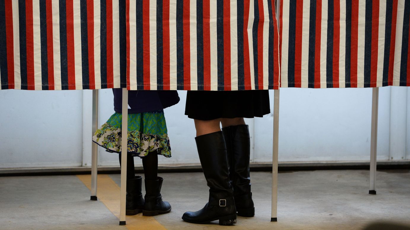 A woman is accompanied by a child as she votes in Loudon, New Hampshire, on Tuesday, February 9.
