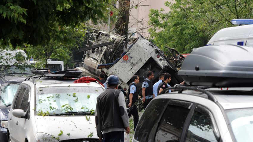 Turkish security officials work at the explosion site after a bus was struck by a bomb in Istanbul, Tuesday, June 7, 2016. 
