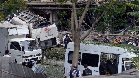 Police officers work at the scene of a car bombing in Istanbul on Tuesday, June 7. At least 11 people were killed and 36 were injured when a car bomb targeted a police bus, according to Turkey's state-run Anadolu agency.