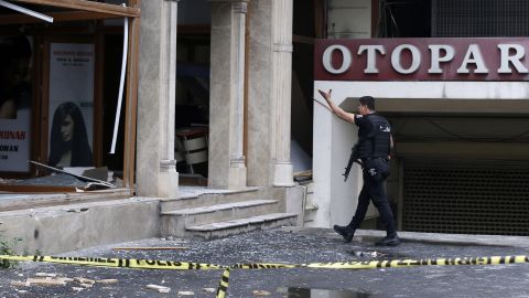 A police officer walks near the scene of the bombing, which happened during morning rush hour.