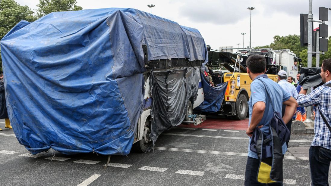 The bus is covered and removed from the scene.