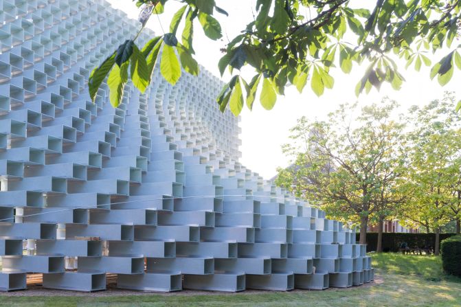 The 273-square-foot pavilion is made from 1,802 stacked fiber glass boxes. Ingels' likens the overall look to a line being "unzipped."
