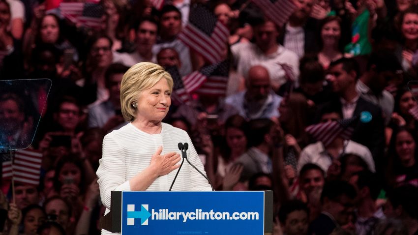 BROOKLYN, NY - JUNE 7: Democratic presidential candidate Hillary Clinton gestures to the crowd at the start of her remarks during a primary night rally at the Duggal Greenhouse in the Brooklyn Navy Yard, June 7, 2016 in the Brooklyn borough of New York City. Clinton has secured enough delegates and commitments from superdelegates to become the Democratic Party's presumptive presidential nominee. She will become the first woman in U.S. history to secure the presidential nomination of one of the country's two major political parties. (Photo by Drew Angerer/Getty Images)
