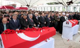 Turkish Prime Minister Binali Yildirim and former Turkish President Abdullah Gul attend the funeral ceremonies of two police officers killed Tuesday.
