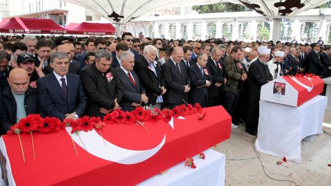 Turkish Prime Minister Binali Yildirim and former Turkish President Abdullah Gul attend the funeral ceremonies of two police officers killed Tuesday.