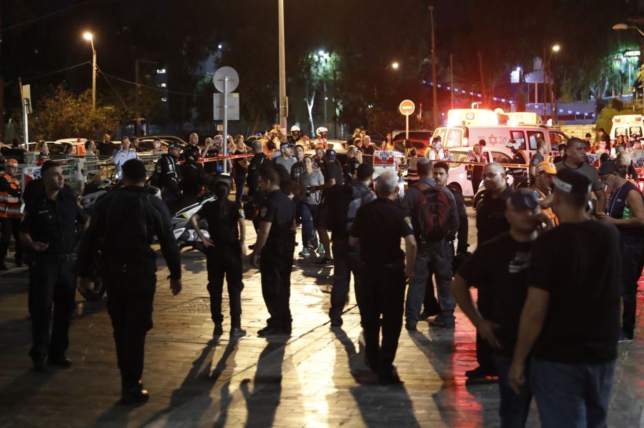 People gather at the site of an attack in Tel Aviv, Israel, on Wednesday, June 8. Several people were killed when terrorists opened fire at a popular market complex, Israeli authorities said.