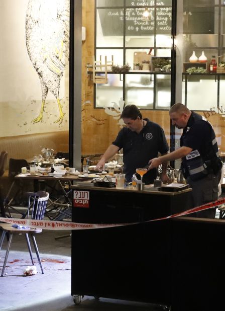 Israeli security forces inspect part of the crime scene. The shooting occurred around 9 p.m. local time at Sarona Market, a mixed-use development with a food hall, upscale retail, playgrounds, green space and residences on a central highway.