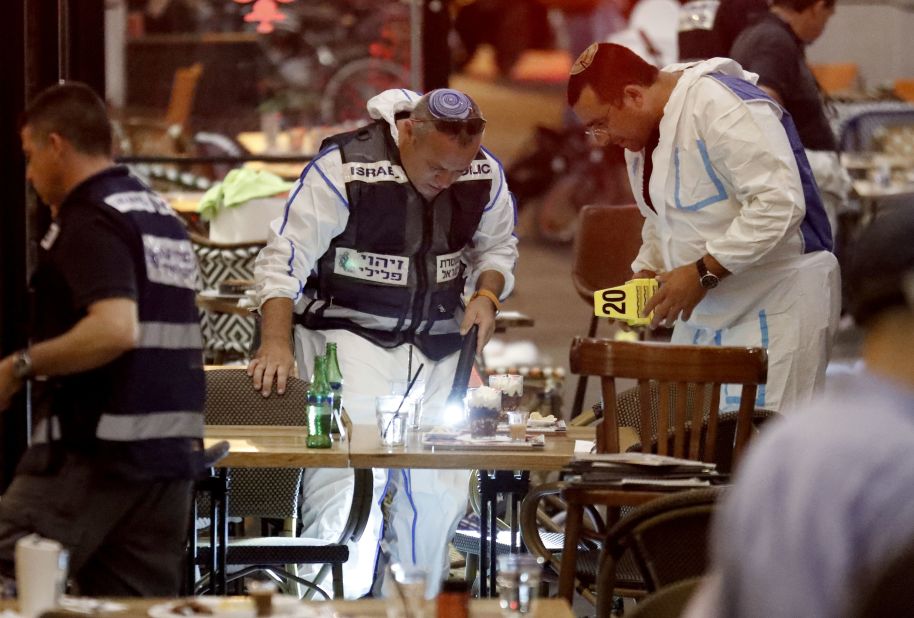 Forensics police inspect a restaurant following the attack.
