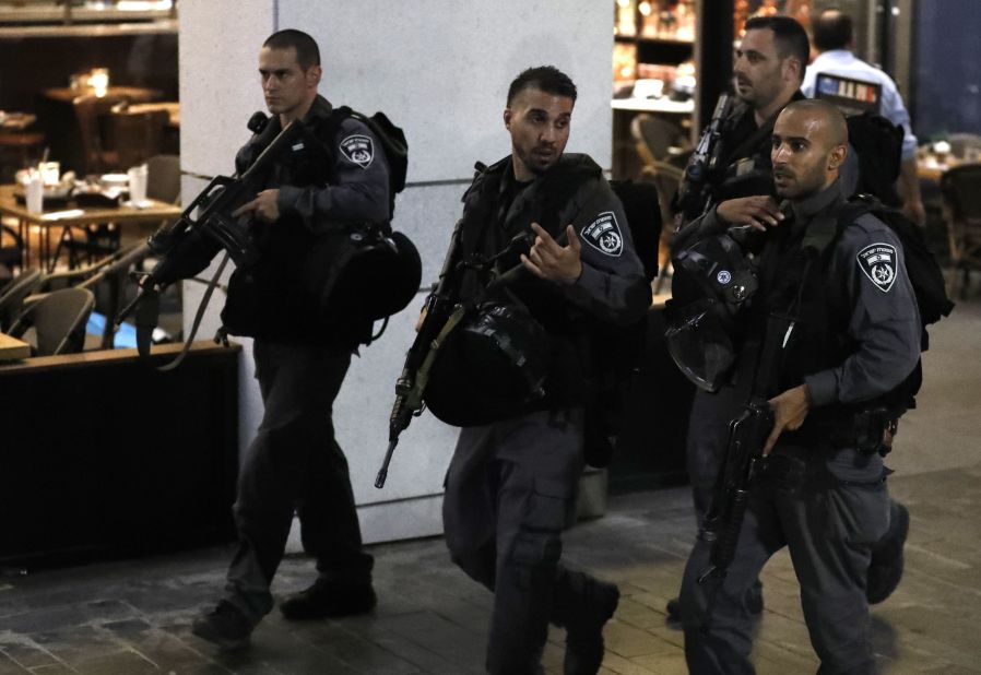 Israeli security forces walk through the shopping complex. The market is across the street from Israel's Defense Ministry and main army headquarters.