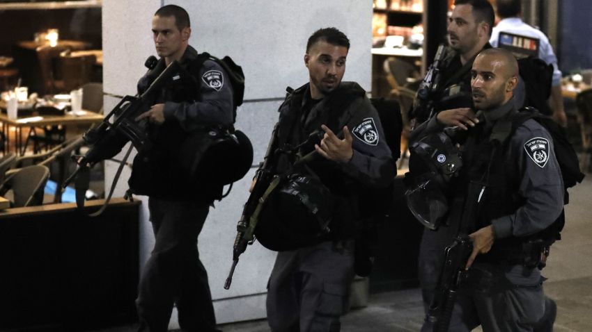 Israeli security forces walk at a shopping complex in the Mediterranean coastal city of Tel Aviv following a shooting attack on June 8, 2016. At least three people were killed and several wounded in the shooting spree, emergency services said. Police said that it appeared to be a militant attack, but they could not immediately give any details of the attacker or victims.