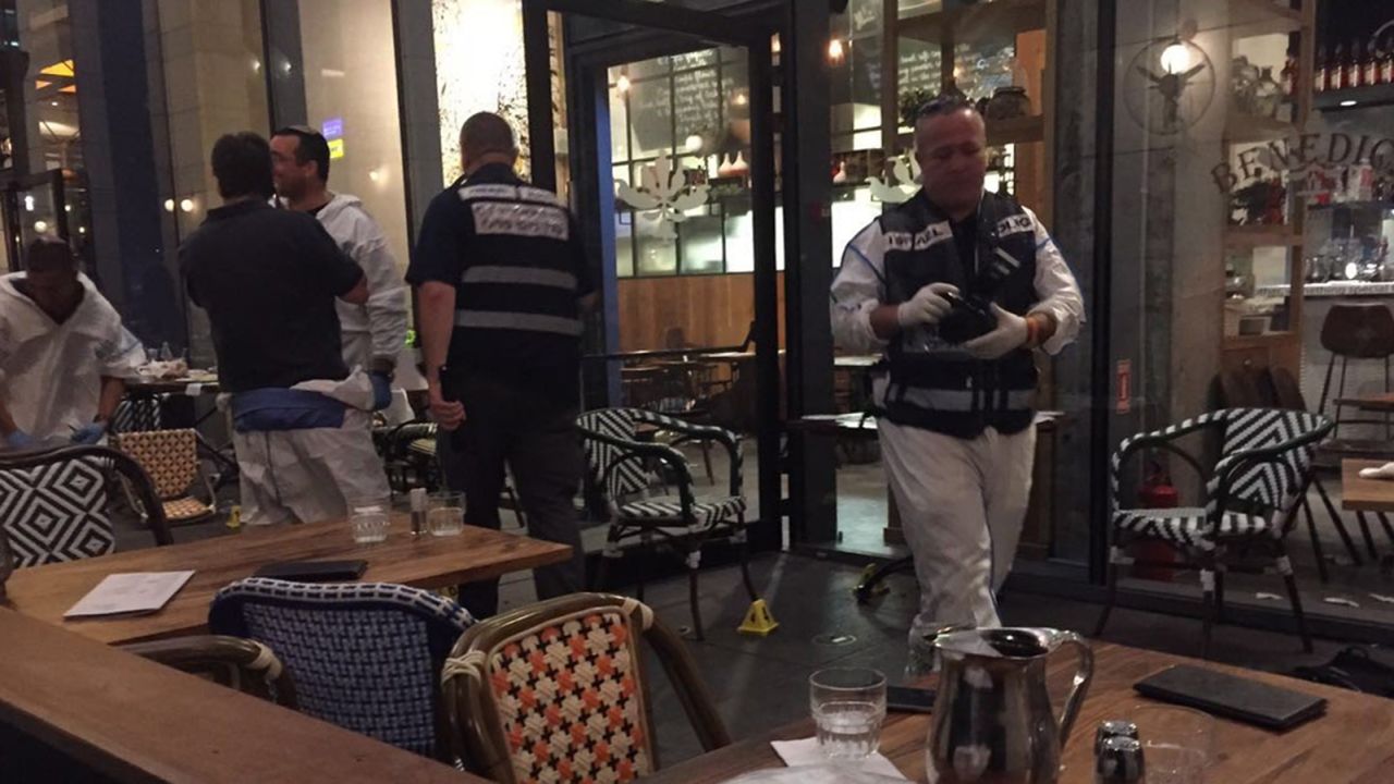 Police survey the scene of a terror attack in Tel Aviv.