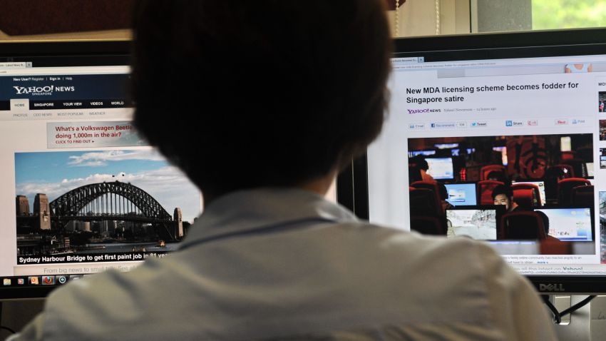 A person browses through media websites on a computer in Singapore on May 30, 2013.  Singapore's official media watchdog on May 30 refuted claims by online critics that a new rule requiring news websites to obtain licences was aimed at stifling Internet freedom.     AFP PHOTO/ROSLAN RAHMAN        (Photo credit should read ROSLAN RAHMAN/AFP/Getty Images)