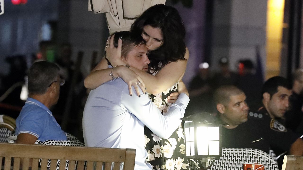 Israelis embrace following the deadly attack Wednesday in Tel Aviv.
