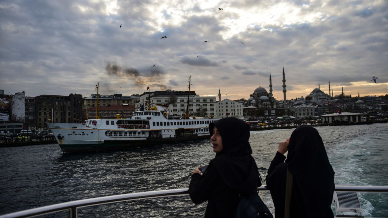 Turkish women stand on the ferry as they travel on the Bosphorus from European side to Anatolia on December 2, 2015, in Istanbul.  / AFP / BULENT KILIC        (Photo credit should read BULENT KILIC/AFP/Getty Images)
