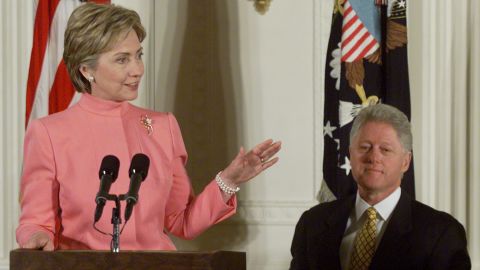 With President Clinton behind her First Lady Hillary makes remarks in the East Room of the White House in 2000. 