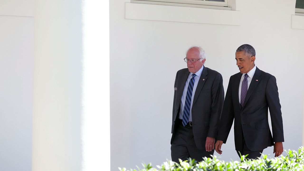 Democratic presidential candidate Sen. Bernie Sanders walks with President Barack Obama through the Colonnade as he arrives at the White House for an Oval Office meeting June 9, 2016 in Washington, DC. 