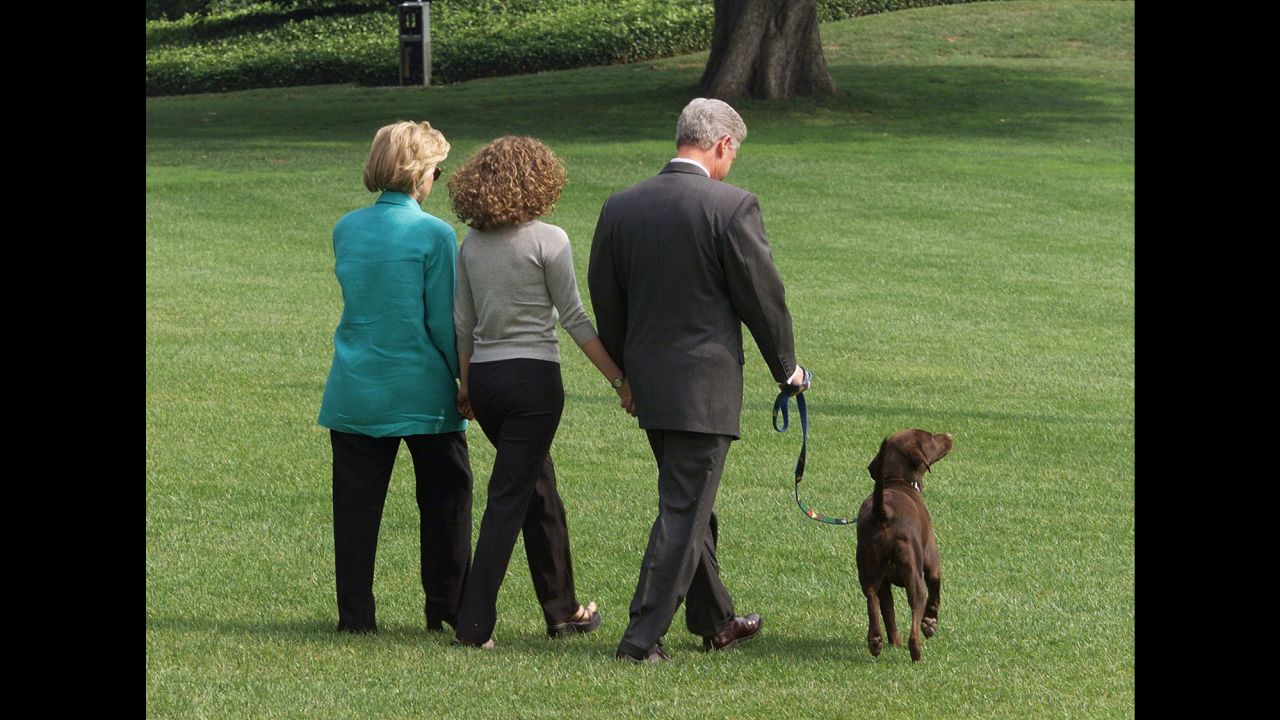 President Bill Clinton, First Lady Hillary Clinton, and their daughter Chelsea depart the White House with their dog Buddy on their way to a two-week vacation in Martha's Vineyard, Massachusetts. Clinton gave a televised address the evening before to the American people from the White House in which he admitted to an improper relationship with former White House intern Monica Lewinsky.