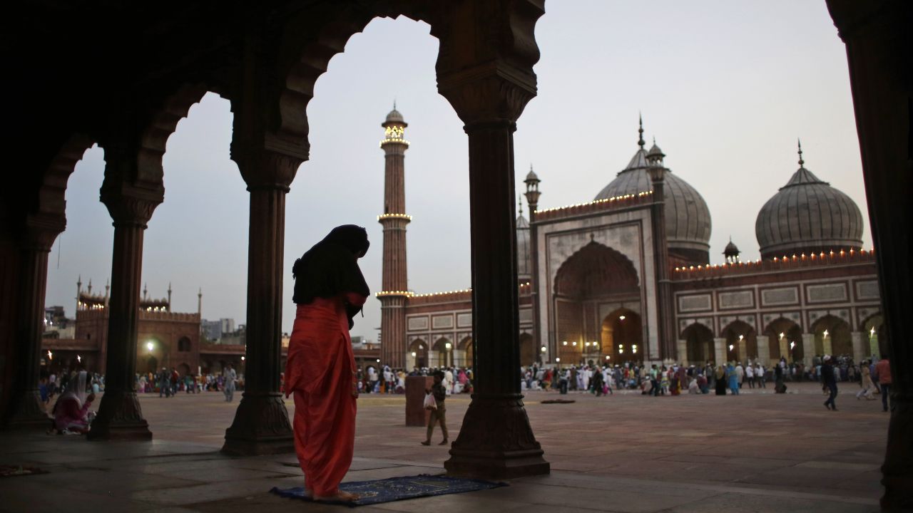 A woman prays after breaking her fast in New Delhi on June 7.