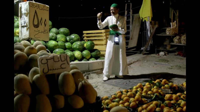 A man in Sidon, Lebanon, wakes up Muslims for their overnight "suhur" meal before the day's fast on June 8. During Ramadan, Muslims fast from dawn until dusk.