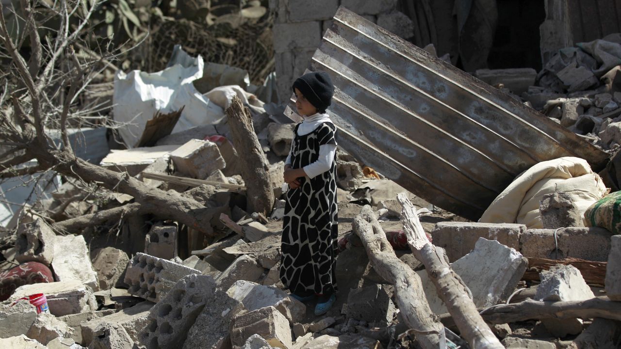 Boy stands in rubble after airstrikes in Sanaa earlier this year.