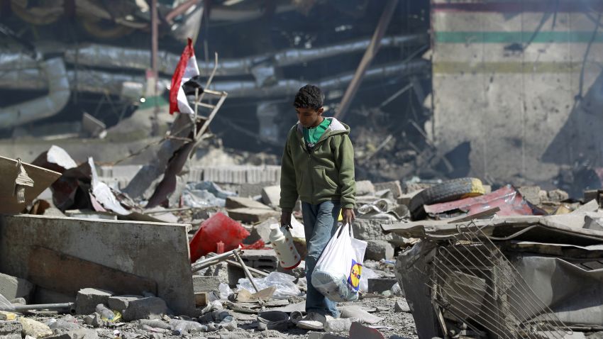 TOPSHOT - A Yemeni boy walks amid the ruins of a school and a bowling club hit by an air-strike carried out by the Saudi-led coalition, in the capital Sanaa, on February 12, 2016.   / AFP / MOHAMMED HUWAIS        (Photo credit should read MOHAMMED HUWAIS/AFP/Getty Images)