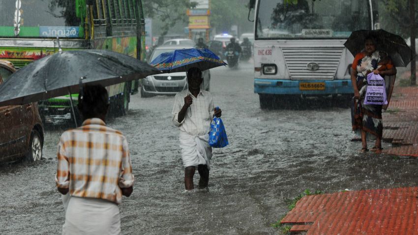 Indian commuters make their way along a waterlogged road during heavy monsoon rains in Kochi on June 08, 2016.
Annual monsoon rains arrived in southern India on June 8, easing fears of millions of desperate farmers after two straight years of drought, the weather department said. Farmers rely on the monsoon rains, which hit the Kerala coast every year and then sweep across the country, to water their crops and replenish dams and reservoirs.
 / AFP / STR        (Photo credit should read STR/AFP/Getty Images)