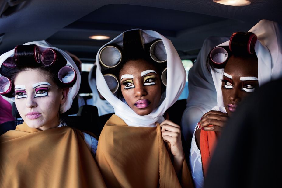 South African model Geraldine Steenkamp and Cameroonian model Valerie Ayena wait in a car before walking for South African designer David Tlale at an outdoor show in the Bo-Kaap area during Cape Town Fashion Week, South Africa.