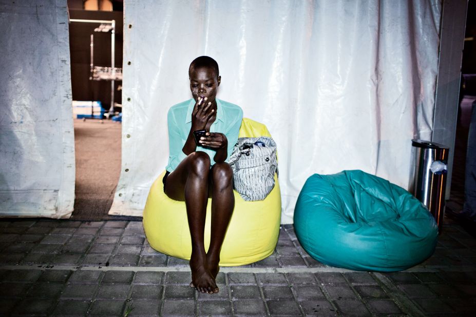 Sudan-born Canadian model Aluad Anei smokes a cigarette backstage during a break between shows during the Fashion Week Joburg on Fitzgerald Square in Newtown, Johannesburg 2013.