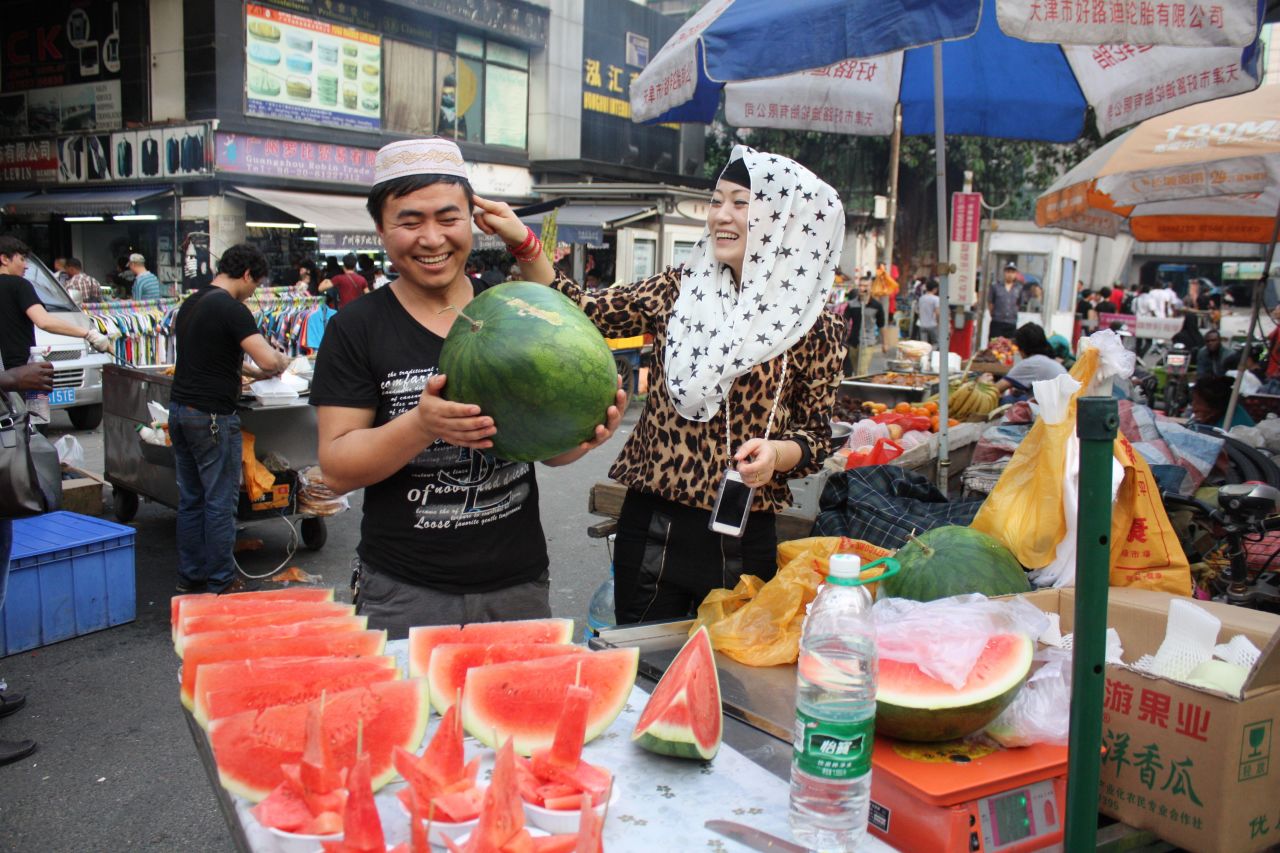 A couple from Xinjiang in north-west China sell fresh fruit in Little Africa. The Dengfeng urban village was home to migrants from across China, as well as Africa.