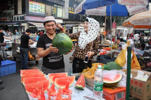 A couple from Xinjiang in north-west China sell fresh fruit in Little Africa. The Dengfeng urban village was home to migrants from across China, as well as Africa.