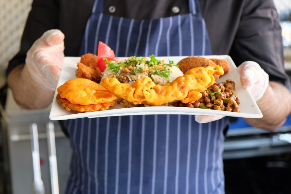 Chef Mohammad Anam Hussain with a freshly made meal at the Shaad restaurant on London's Brick Lane
