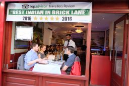 Diners choose from a long list of curries on London's Brick Lane. 