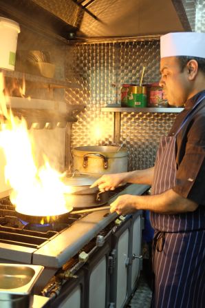 Head chef of the Shaad restaurant Mohammad Anam Hussain cooks a chick pea curry.