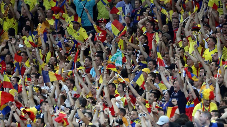 Romania's fans rejoice in the stands after Stancu's penalty.