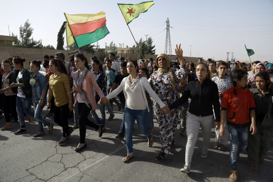 Syrian Kurds march at the funeral of fighters who died fighting ISIS in Manbij.