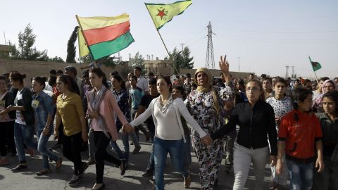 Syrian Kurds march at the funeral of fighters who died fighting ISIS in Manbij.