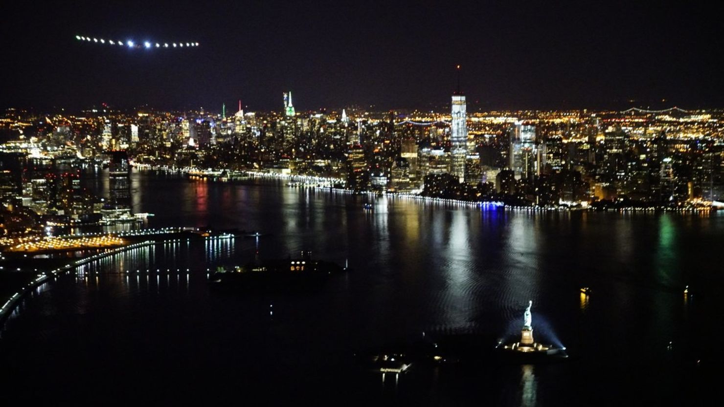 Solar Impulse 2 flies above New York City and the Statue of Liberty.
