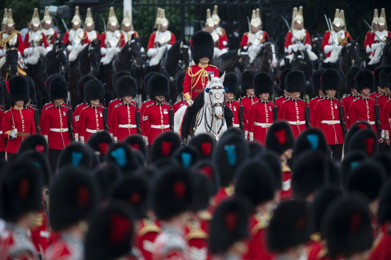 Members of The Foot Guards and The Household Cavalry march. The monarch is technically the head of Britain's armed forces, and would traditionally lead an army into war. The parade gives the Queen a chance to review and approve her army.