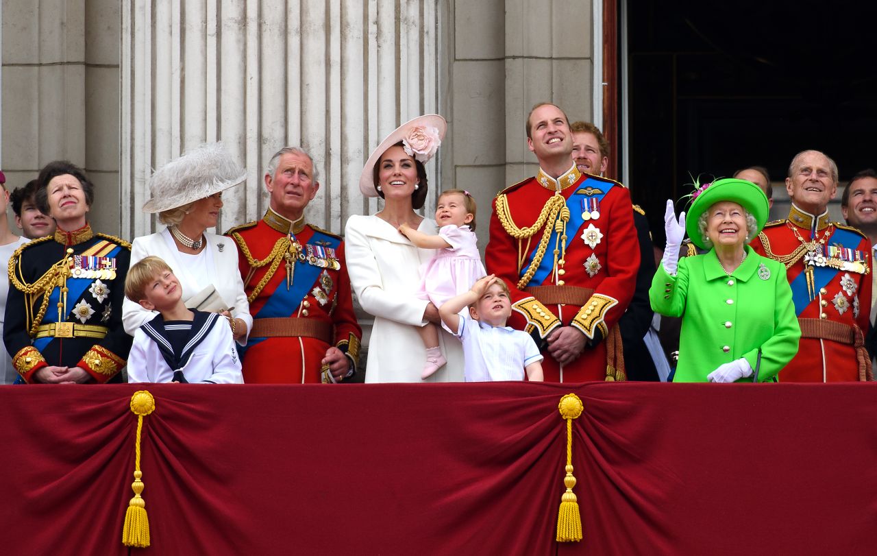 Members of the royal family gather on a balcony in June 2016, during celebrations marking the 90th birthday of Queen Elizabeth II. From left are Princess Anne; Camilla, the Duchess of Cornwall; Prince Charles; Catherine, the Duchess of Cambridge; Princess Charlotte; Prince George; Prince William; Prince Harry; Queen Elizabeth II; and Prince Philip.