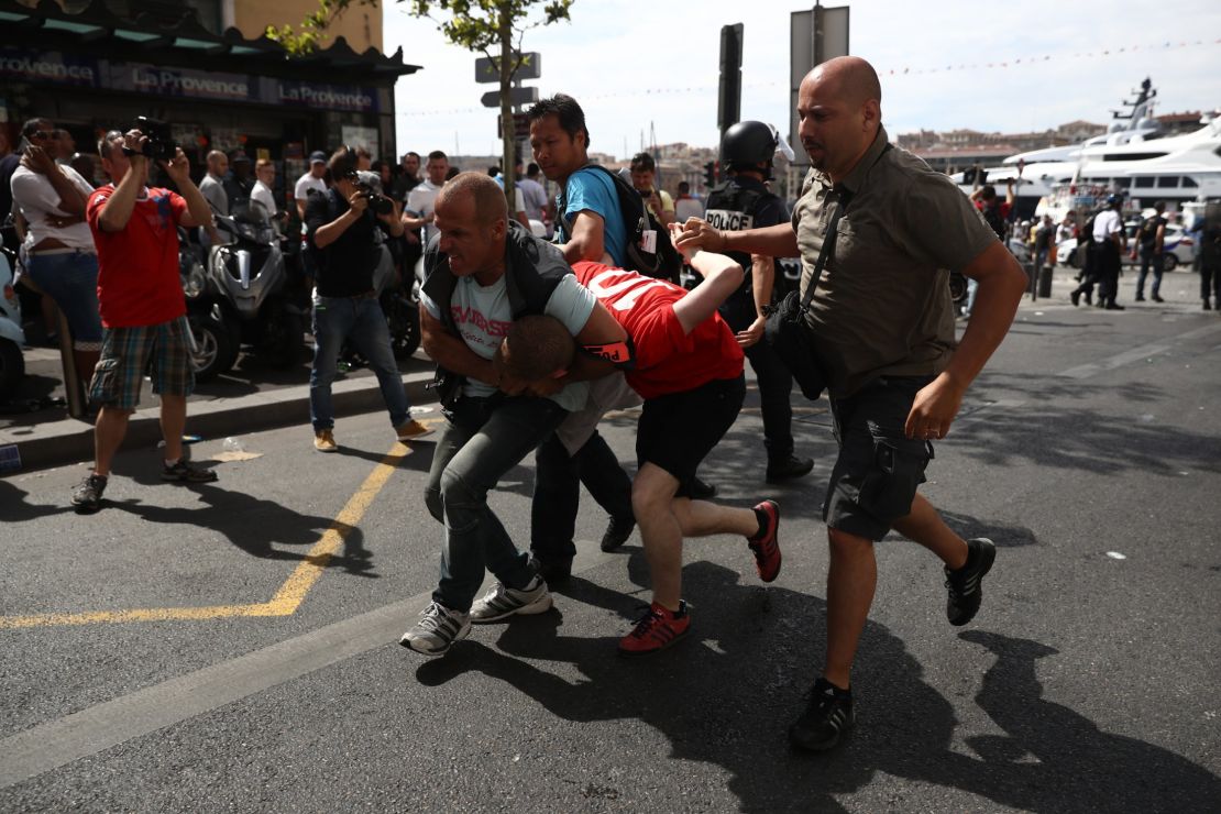 Fans skirmish ahead of the match in the French port city of Marseille on Saturday.