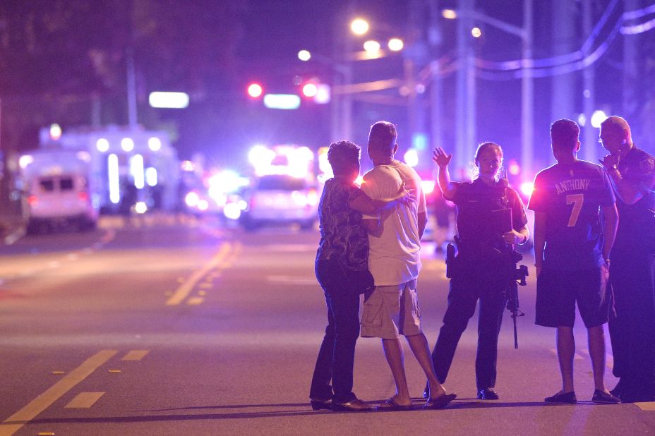 Police in Orlando direct family members away from the scene of the shooting.