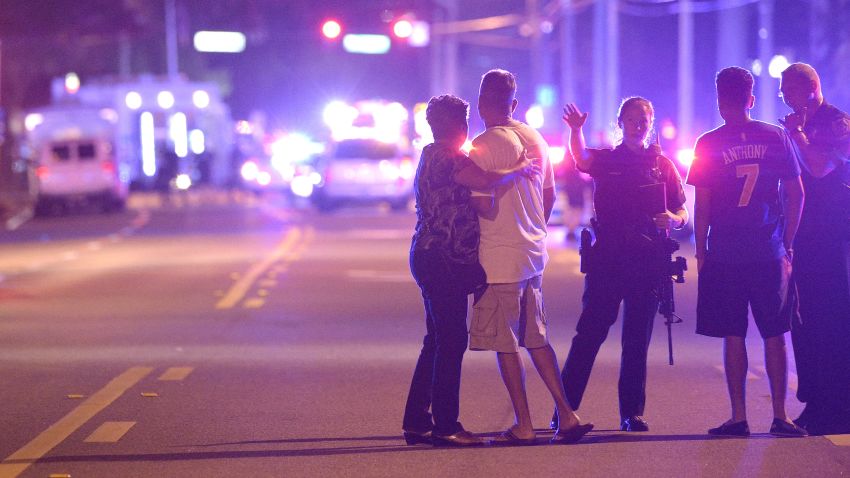 Orlando Police officers direct family members away from a multiple shooting at a nightclub in Orlando, Fla., Sunday, June 12, 2016. A gunman opened fire at a nightclub in central Florida, and multiple people have been wounded, police said Sunday. 