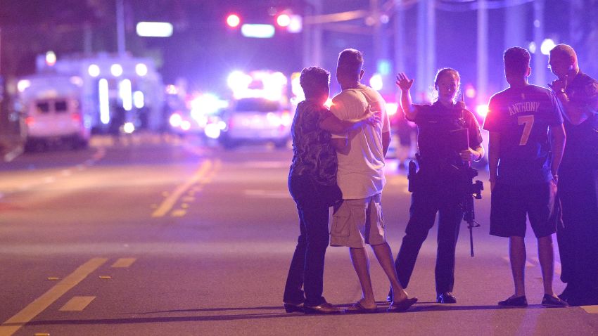 Orlando Police officers direct family members away from a multiple shooting at a nightclub in Orlando, Fla., Sunday, June 12, 2016. A gunman opened fire at a nightclub in central Florida, and multiple people have been wounded, police said Sunday.