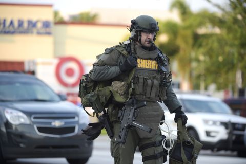 A SWAT team member arrives at the scene of the shooting.