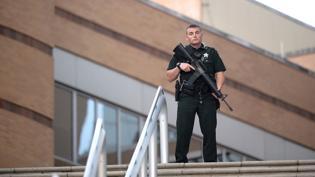 A police officer stands guard outside the Orlando Regional Medical Center.